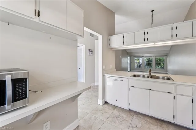 a kitchen with cabinets and window