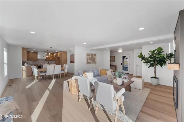 a living room with furniture a potted plant and a table