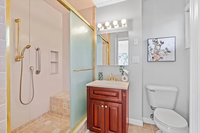 a bathroom with a granite countertop toilet sink and shower