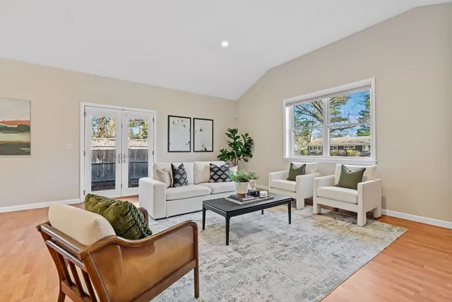 a living room with furniture couches and a large window