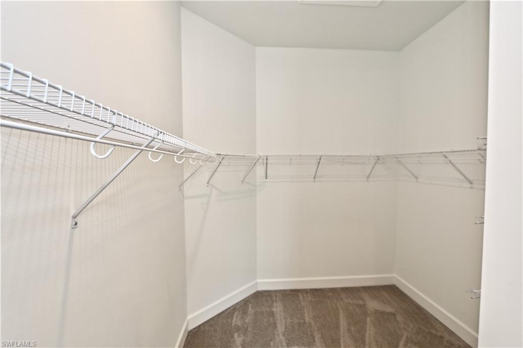 8437 Rosa Court Naples, FL 34114 - Photo 11 of 32 a view of a room with racks on the wall