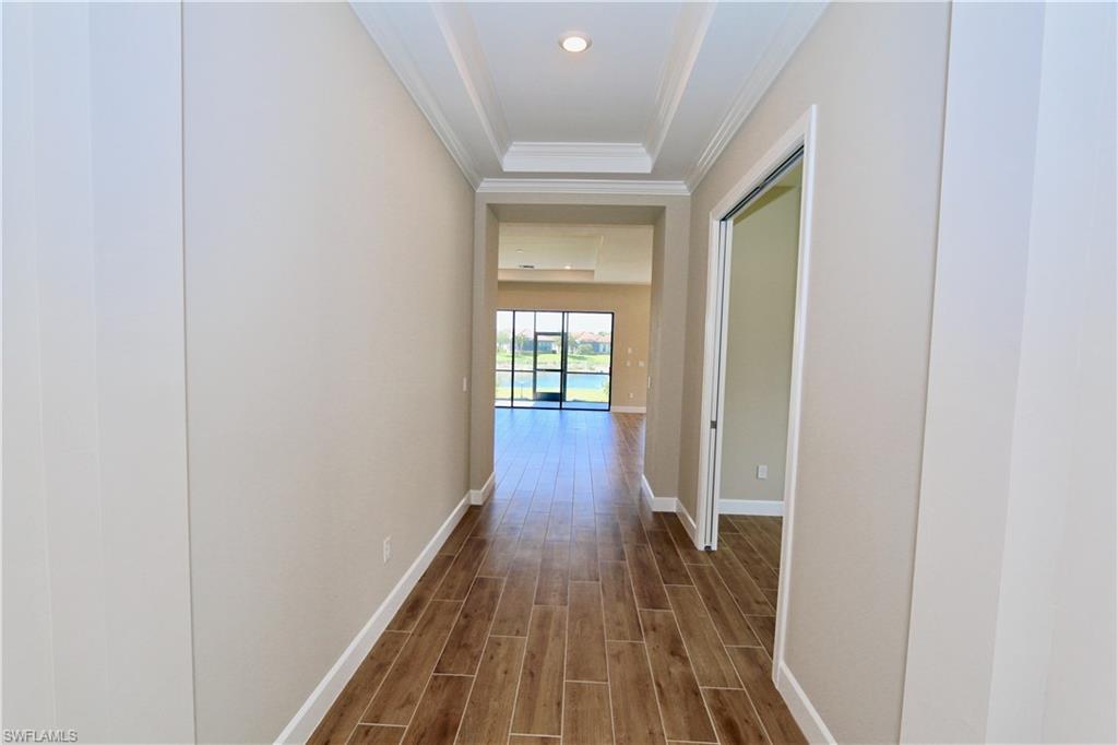 8437 Rosa Court Naples, FL 34114 - Photo 12 of 32 a view of a hallway with wooden floor