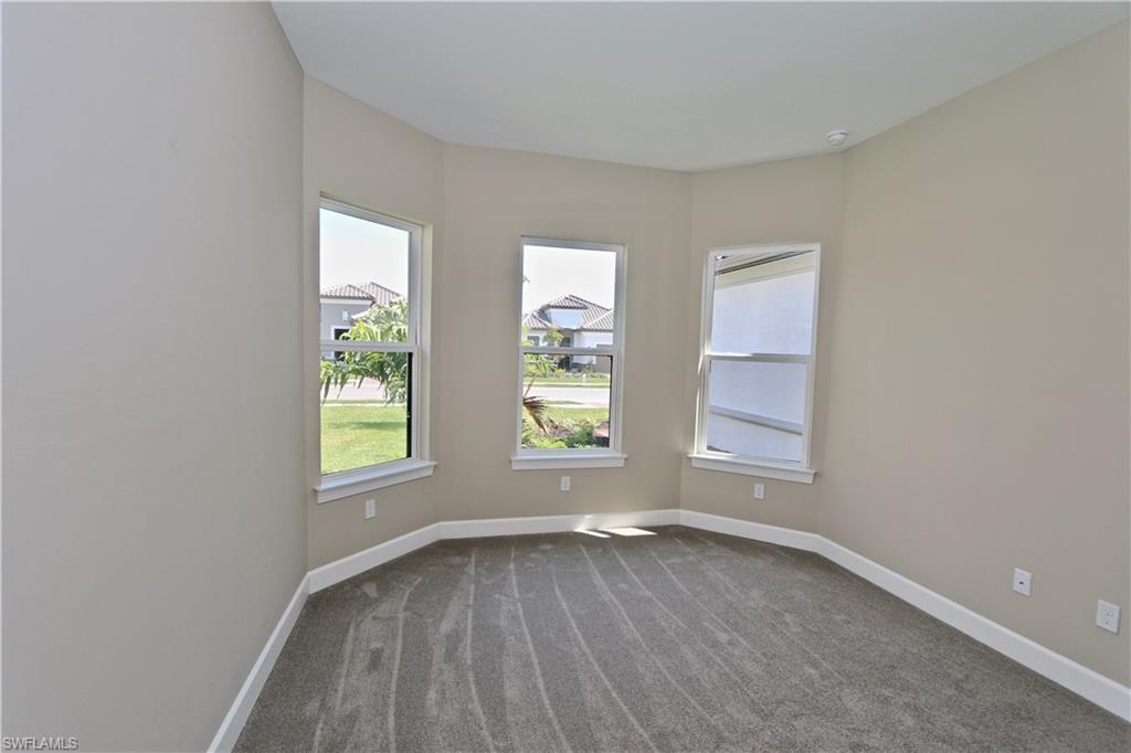 8437 Rosa Court Naples, FL 34114 - Photo 13 of 32 an empty room with windows