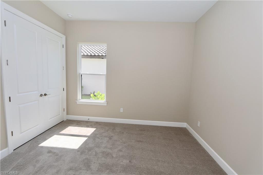 8437 Rosa Court Naples, FL 34114 - Photo 14 of 32 an empty room with windows and closet