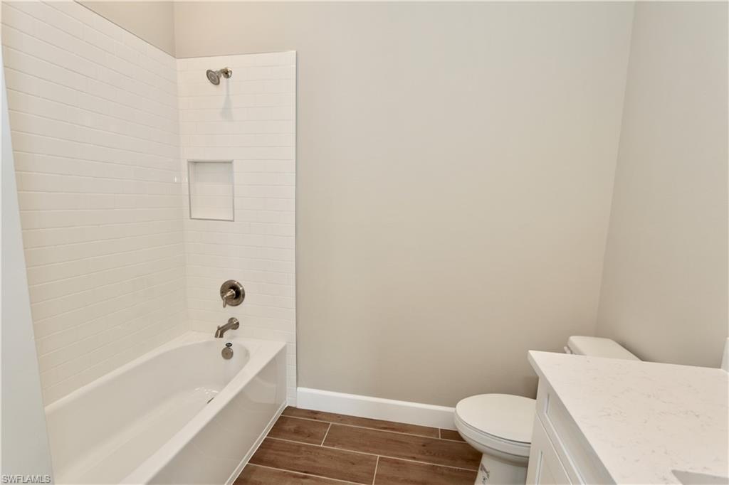 8437 Rosa Court Naples, FL 34114 - Photo 15 of 32 a bathroom with a bathtub and toilet