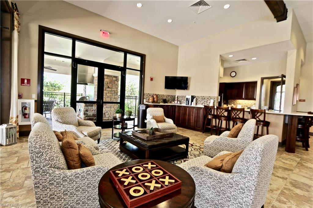8437 Rosa Court Naples, FL 34114 - Photo 25 of 32 a living room with furniture and a floor to ceiling window