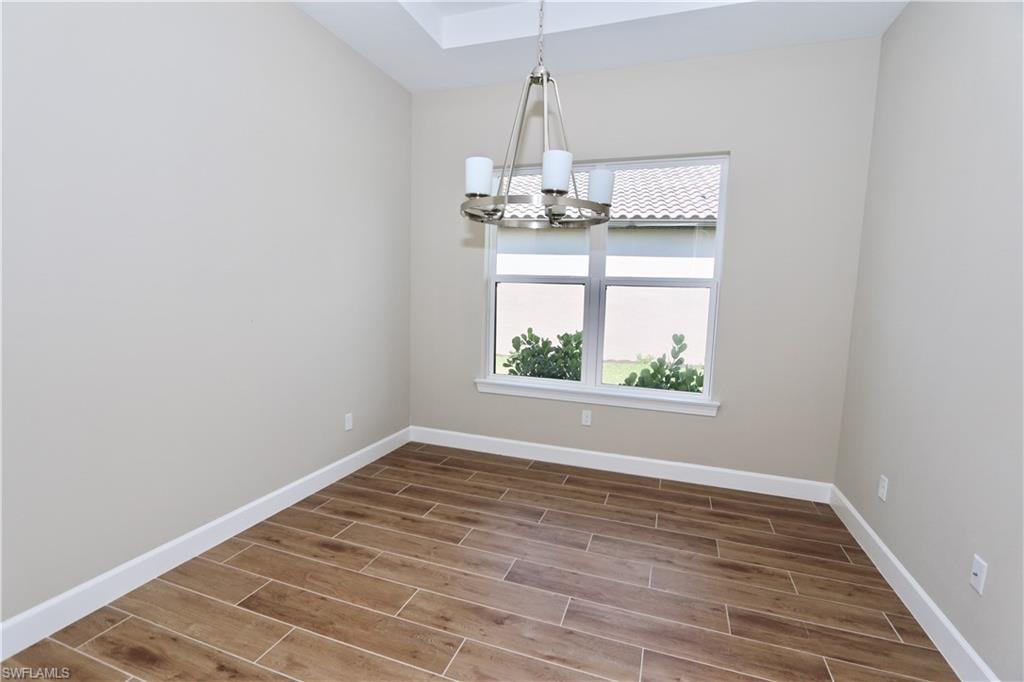8437 Rosa Court Naples, FL 34114 - Photo 7 of 32 a view of a room with wooden floor fan and window