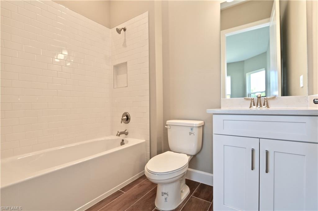 8437 Rosa Court Naples, FL 34114 - Photo 8 of 32 a bathroom with a sink a toilet and shower