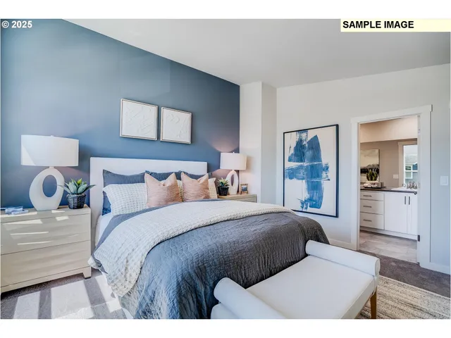 a bedroom with a bed a mirror and a large window