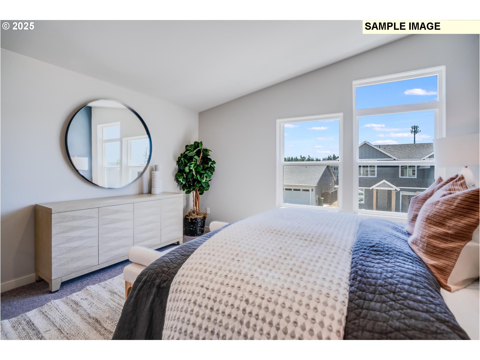 23809 Southwest Black Tortoise Terrace Tualatin, OR 97062 - Photo 14 of 26 a bedroom with a bed a mirror and a large window