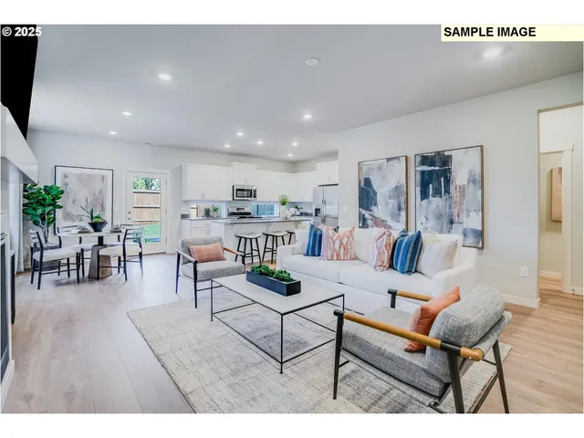 a living room with furniture and kitchen view