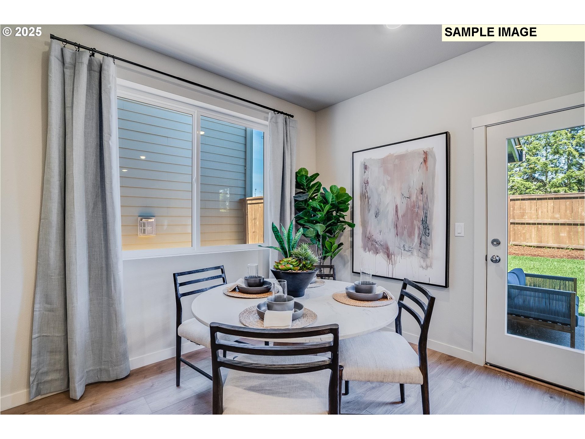 23809 Southwest Black Tortoise Terrace Tualatin, OR 97062 - Photo 6 of 26 a view of a dining room with furniture window and wooden floor