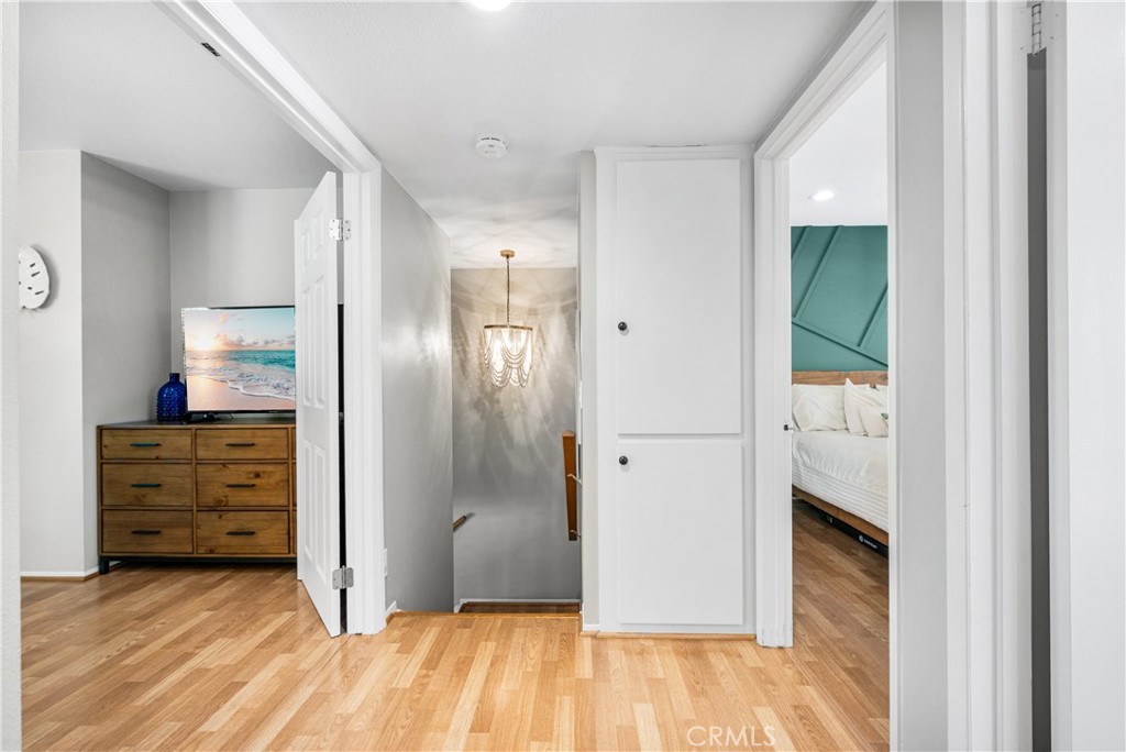 4237 Larwin Avenue Cypress, CA 90630 - Photo 21 of 48 a view of a hallway with wooden floor cabinet and a bathroom
