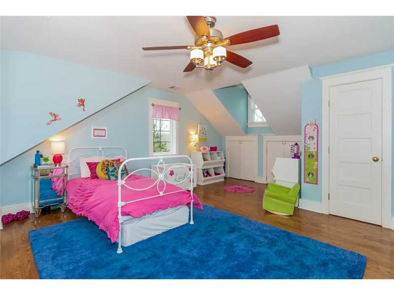16 Locust Hill Road Darien, CT 06820 - Photo 20 of 25 a bedroom with a bed and a chandelier