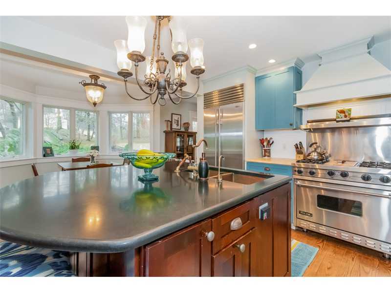 16 Locust Hill Road Darien, CT 06820 - Photo 8 of 25 a kitchen with stainless steel appliances granite countertop a sink a stove and chairs