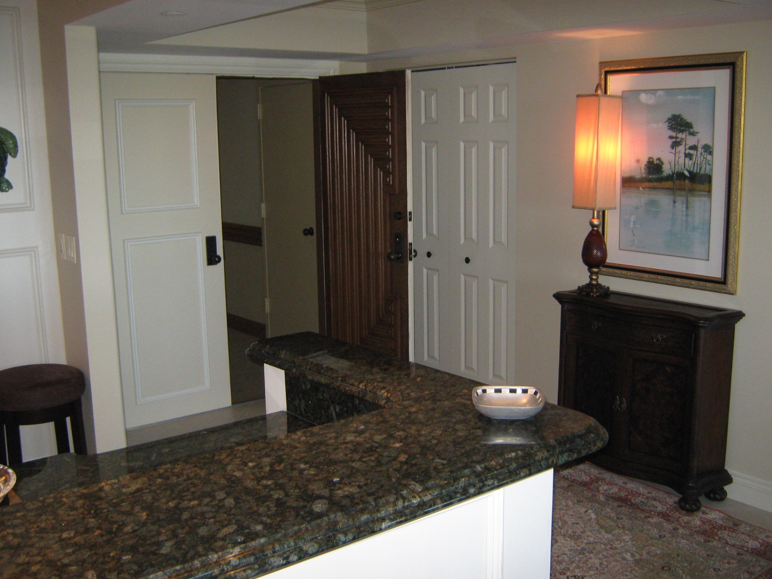 19670 South Beach Road, Unit PHB4 Jupiter, FL 33469 - Photo 11 of 35 a view of a hallway with wooden cabinets