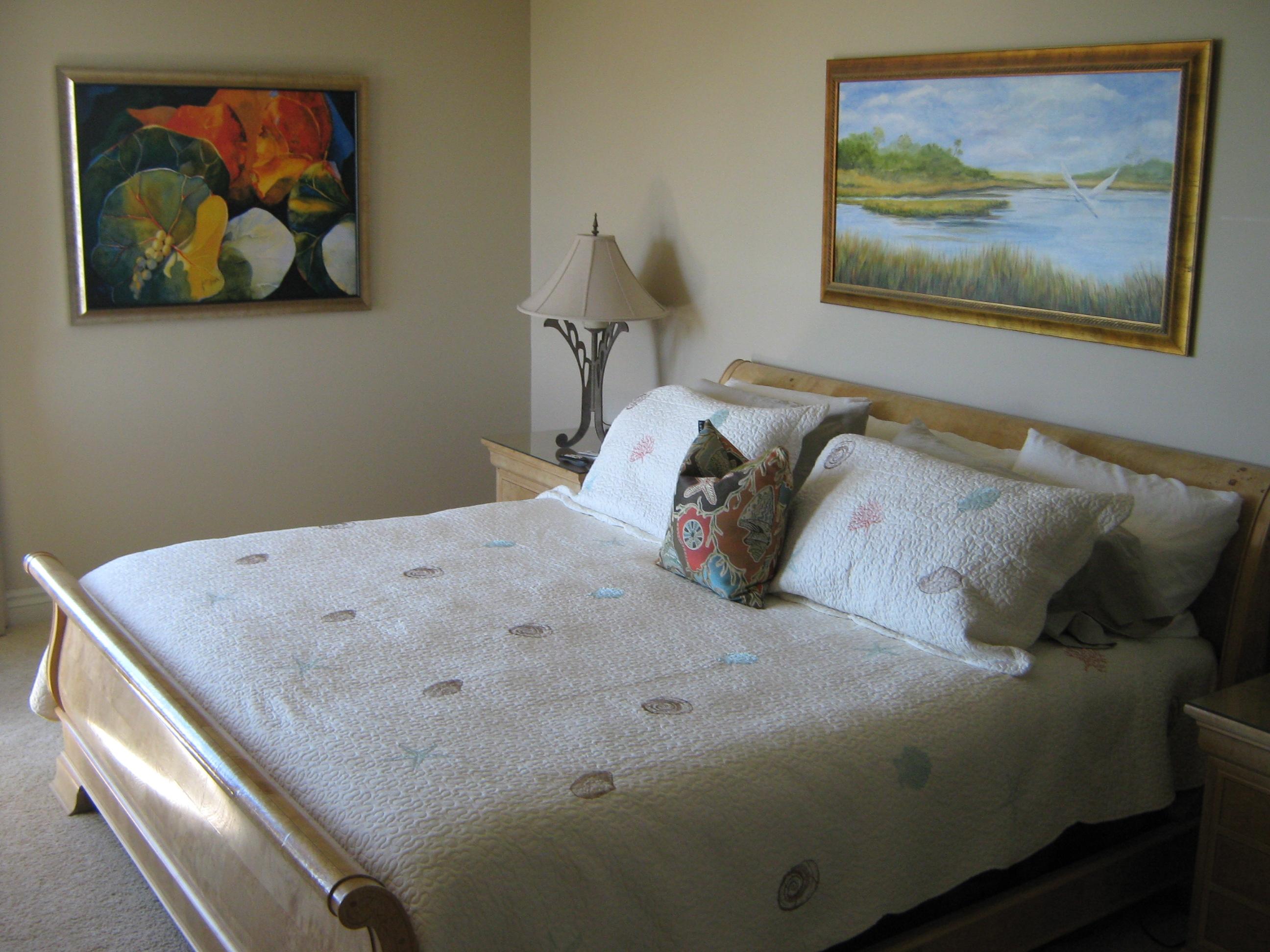 19670 South Beach Road, Unit PHB4 Jupiter, FL 33469 - Photo 23 of 35 a bed with a painting on the wall and a painting on the wall