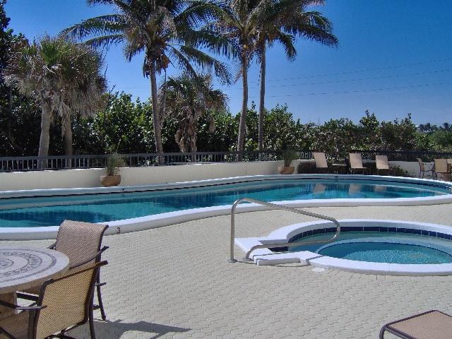 19670 South Beach Road, Unit PHB4 Jupiter, FL 33469 - Photo 32 of 35 a view of a swimming pool with a lounge chair
