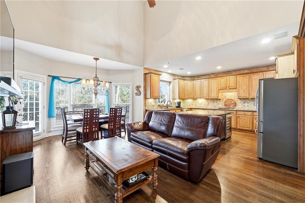 585 Tilbury Drive Suwanee, GA 30024 - Photo 11 of 46 a living room with furniture wooden floor and large windows