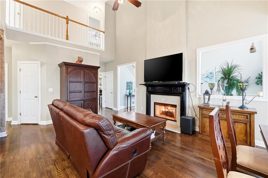 585 Tilbury Drive Suwanee, GA 30024 - Photo 12 of 46 a living room with furniture a fireplace and a flat screen tv