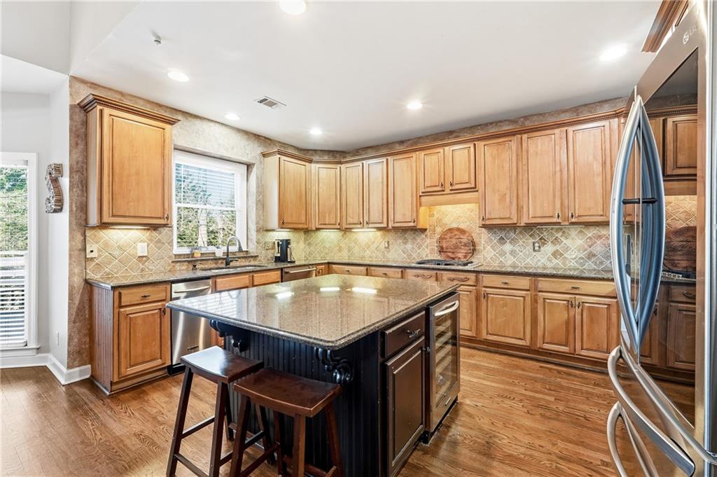 585 Tilbury Drive Suwanee, GA 30024 - Photo 14 of 46 a kitchen with stainless steel appliances granite countertop a stove a sink dishwasher and a refrigerator