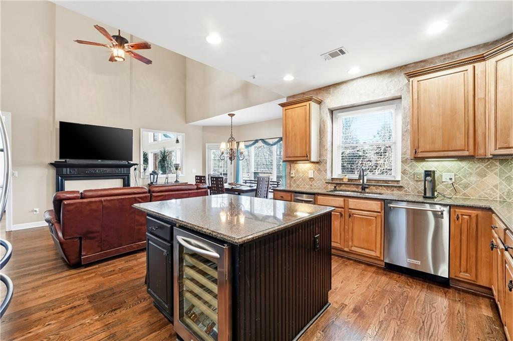 585 Tilbury Drive Suwanee, GA 30024 - Photo 15 of 46 a kitchen with kitchen island granite countertop a sink appliances and cabinets