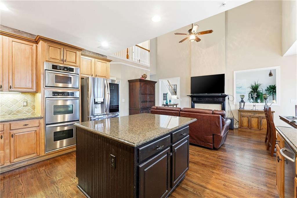 585 Tilbury Drive Suwanee, GA 30024 - Photo 16 of 46 a kitchen with stainless steel appliances granite countertop a sink a stove and a refrigerator