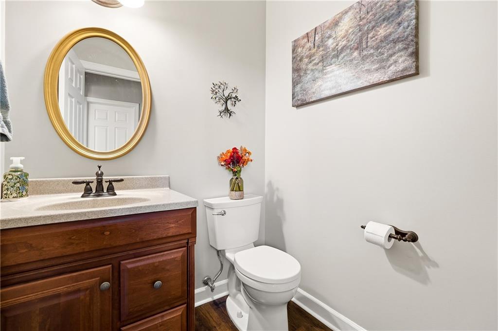 585 Tilbury Drive Suwanee, GA 30024 - Photo 18 of 46 a bathroom with a toilet a sink and a mirror