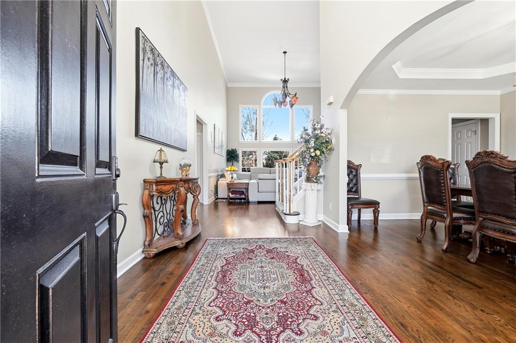 585 Tilbury Drive Suwanee, GA 30024 - Photo 3 of 46 a living room with furniture and a wooden floor