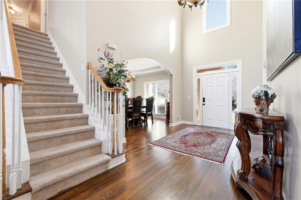 585 Tilbury Drive Suwanee, GA 30024 - Photo 4 of 46 a view of a hallway with wooden floor and staircase