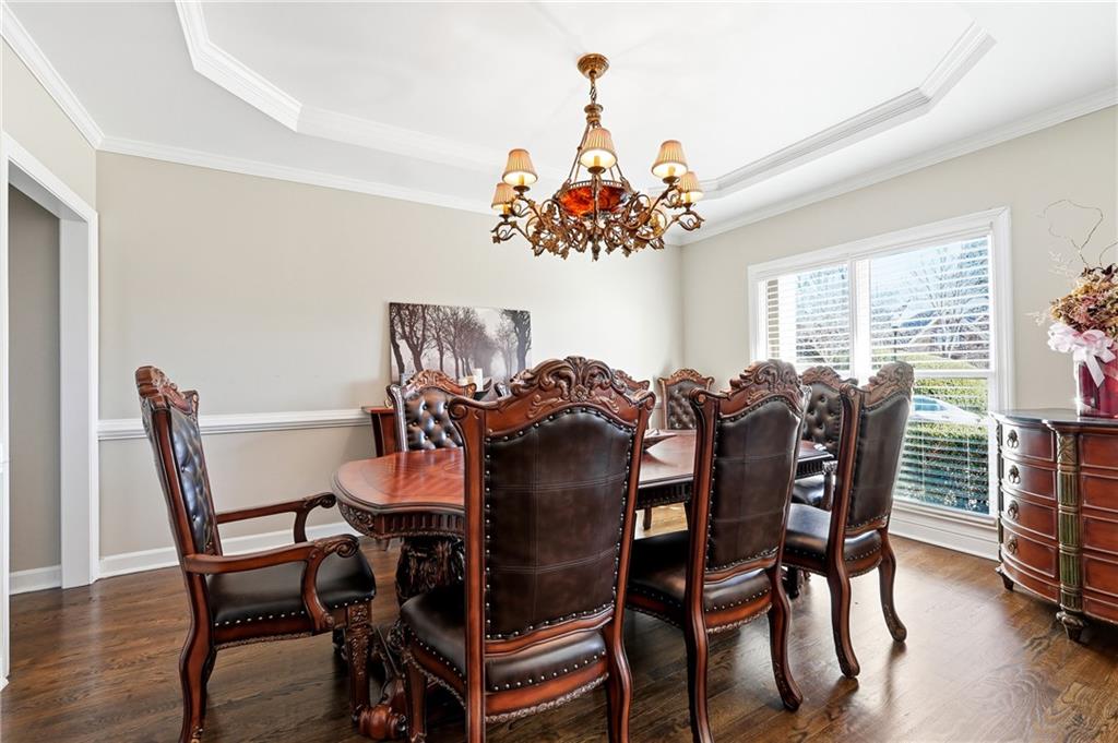 585 Tilbury Drive Suwanee, GA 30024 - Photo 6 of 46 a view of a dining room with furniture and chandelier