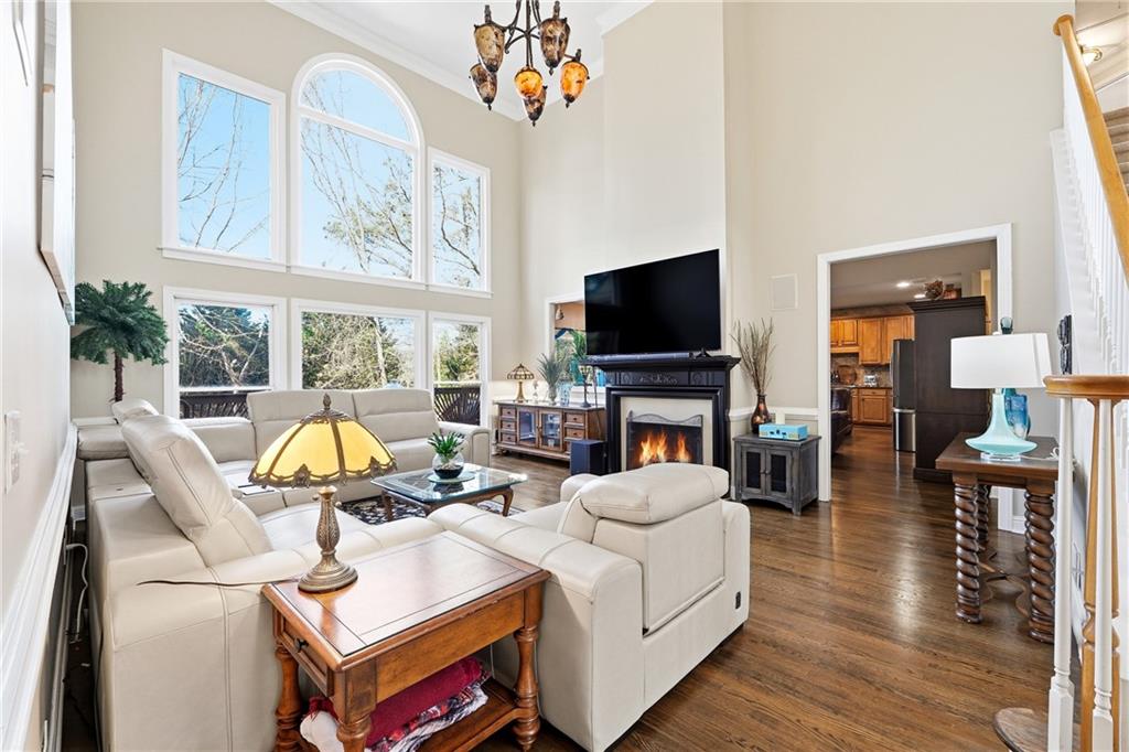 585 Tilbury Drive Suwanee, GA 30024 - Photo 7 of 46 a work room with furniture a flat screen tv and a floor to ceiling window