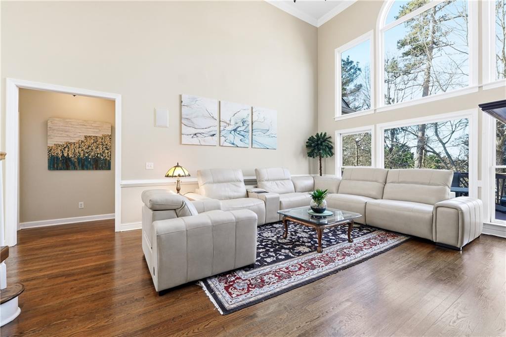 585 Tilbury Drive Suwanee, GA 30024 - Photo 9 of 46 a living room with furniture and a large window