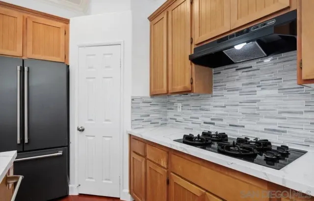 a kitchen with a stove and a refrigerator