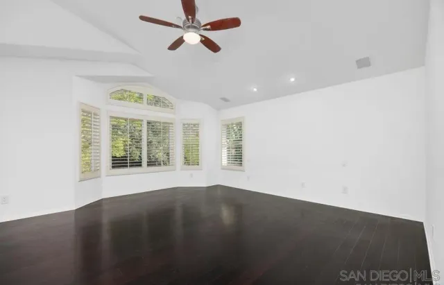 a view of a livingroom with a ceiling fan and window