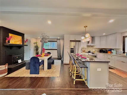 a kitchen with stainless steel appliances kitchen island granite countertop a sink and a stove