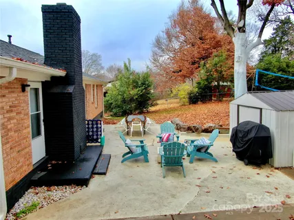 a view of a chair and table in backyard