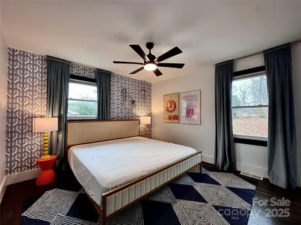 a bedroom with a bed and a window with outer view