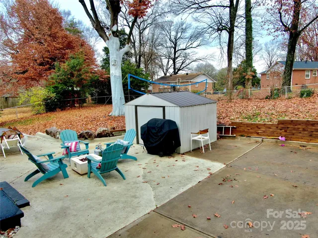 a view of a house with backyard stove and sitting area