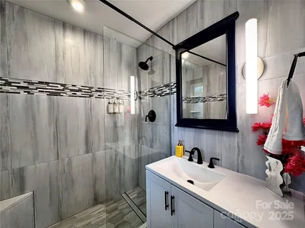 a bathroom with a sink toilet and shower