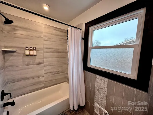 a bathroom with a bathtub and a shower