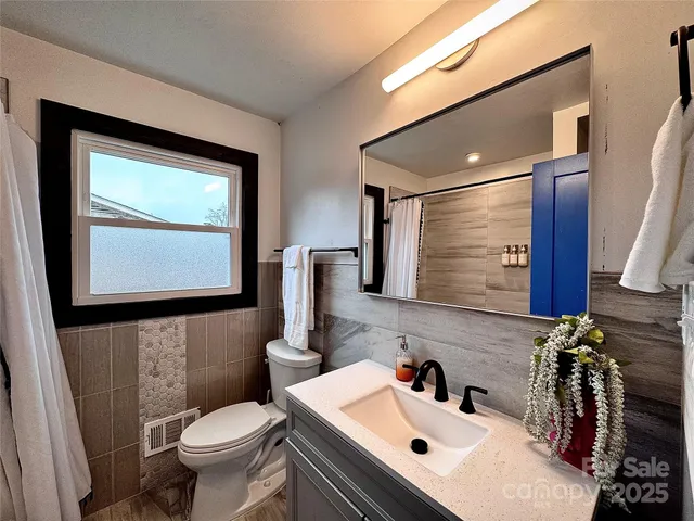 a bathroom with a sink toilet and mirror
