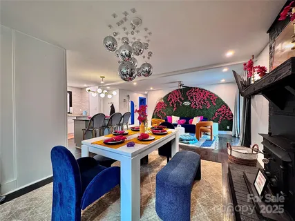 a outdoor dining space with furniture and a chandelier