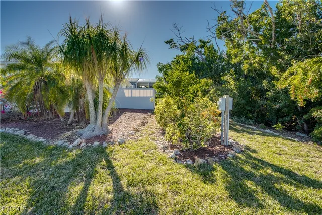 a garden with trees in front of it