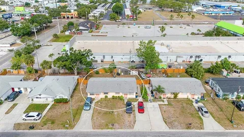 an aerial view of residential houses with outdoor space and swimming pool