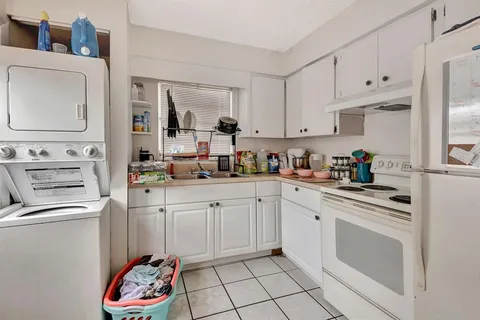 a kitchen with cabinets appliances and a sink