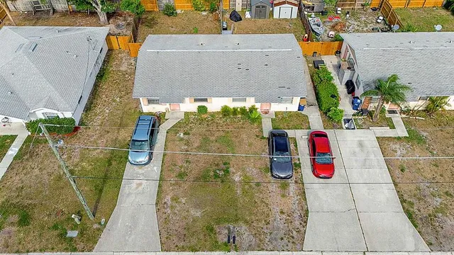 an aerial view of residential houses with outdoor space