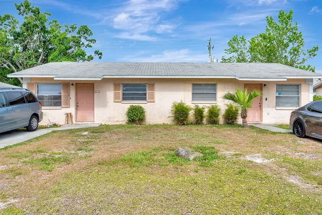 a view of a house with a yard and garage
