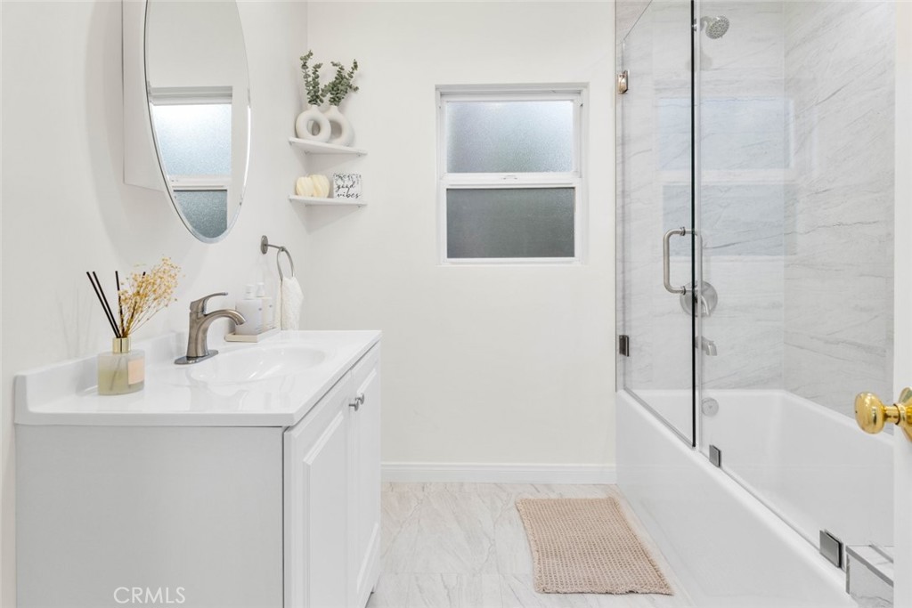 10554 Plainview Avenue Tujunga, CA 91042 - Photo 18 of 56 a bathroom with a bathtub sink and mirror