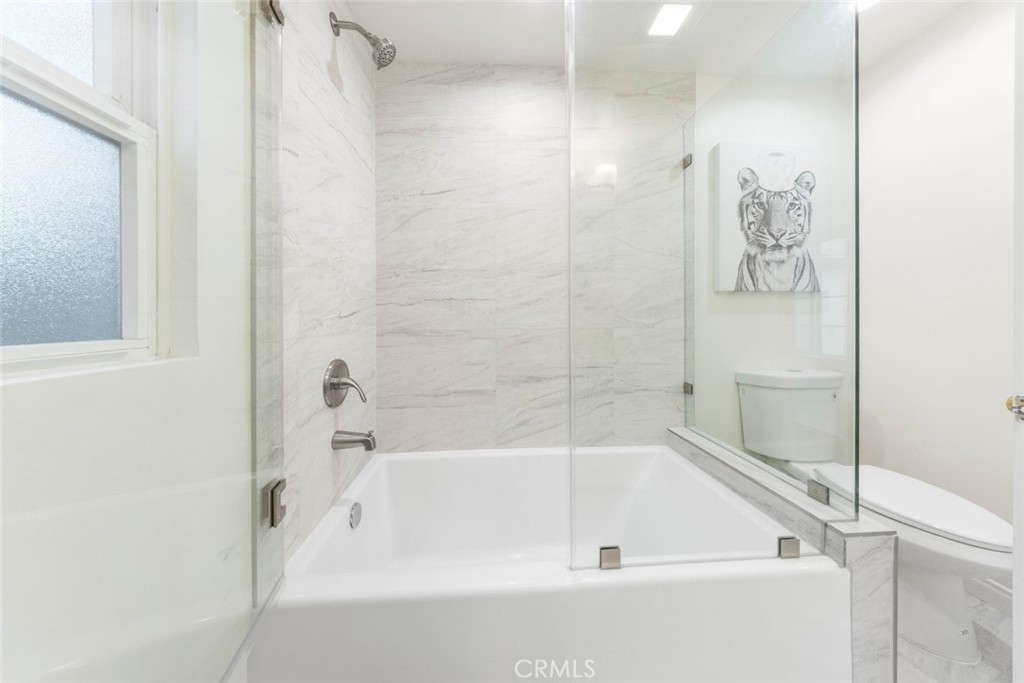 10554 Plainview Avenue Tujunga, CA 91042 - Photo 19 of 56 a bathroom with a bathtub and shower